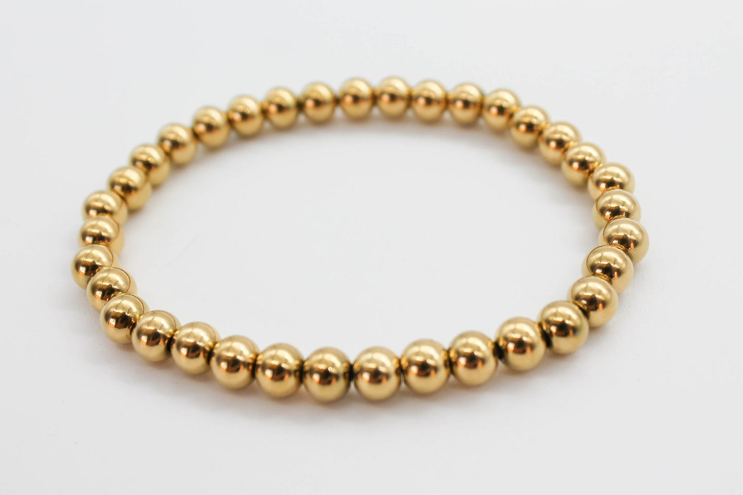 PULSERA ELASTICO ESFERAS 3 MM, TONO DORADO