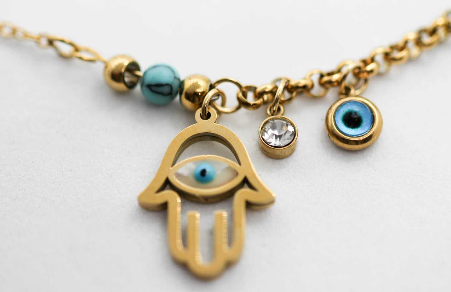 PULSERA MANO DE FATIMA MITAD DELGADA/ MITAD GRUESA ESFERA AZUL, CIRCONIA OJO COLGANDO,18CM + EXTENSION 4CM