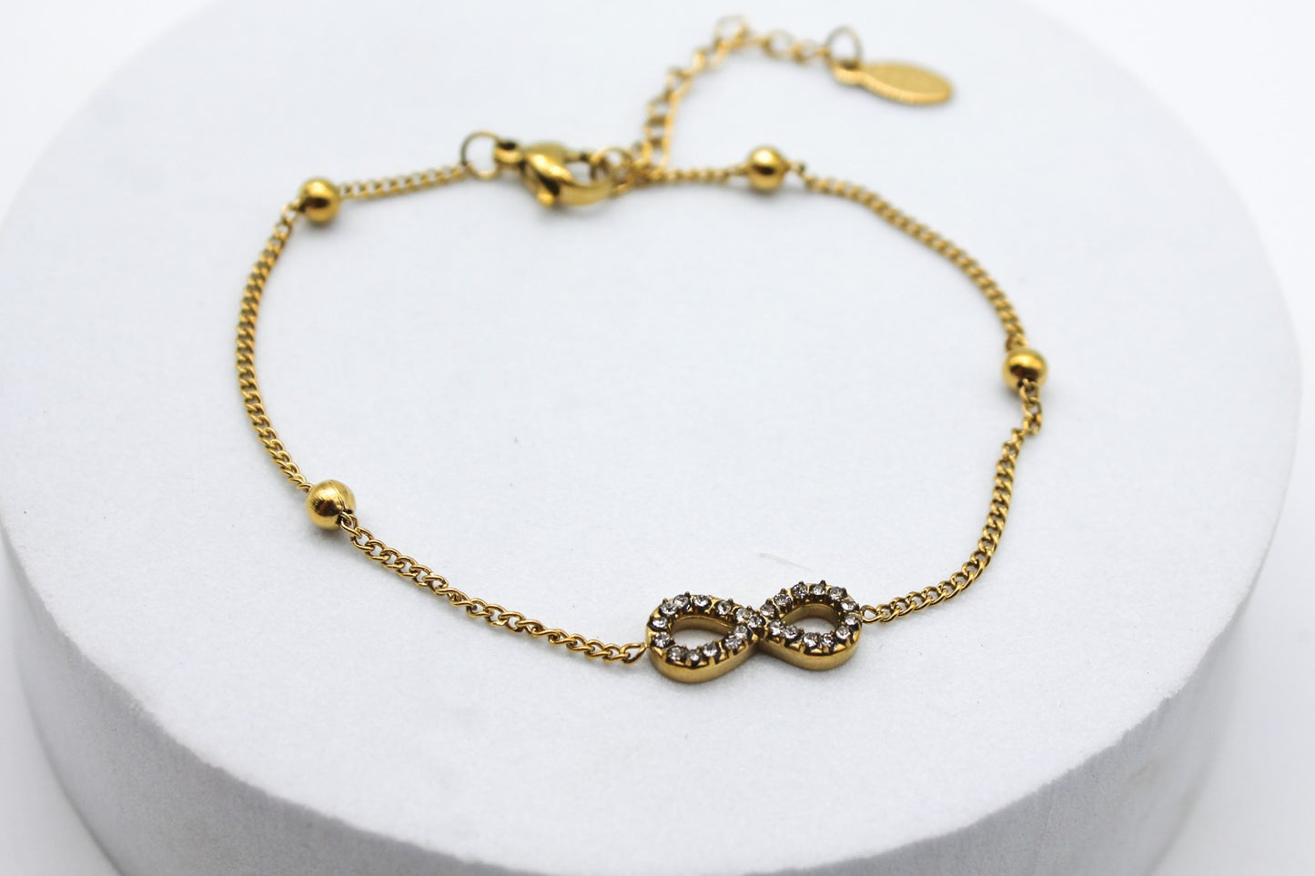 PULSERA INFINITO CIRCONIAS Y ESFERITAS; TONO DORADO