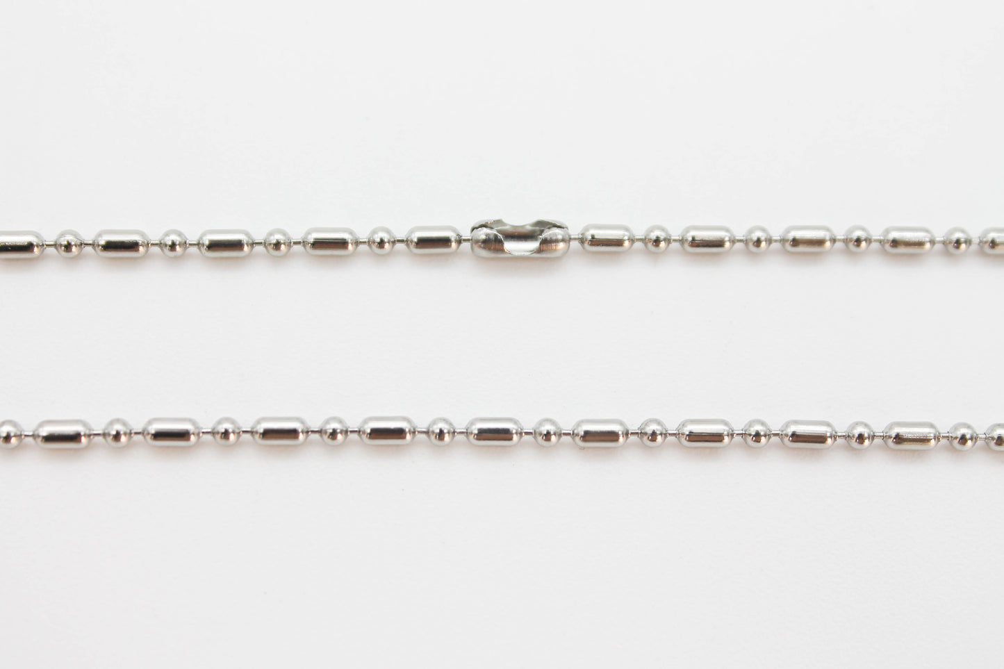 CRUZ LISA CON CADENA 70 CM, TONO PLATEADO