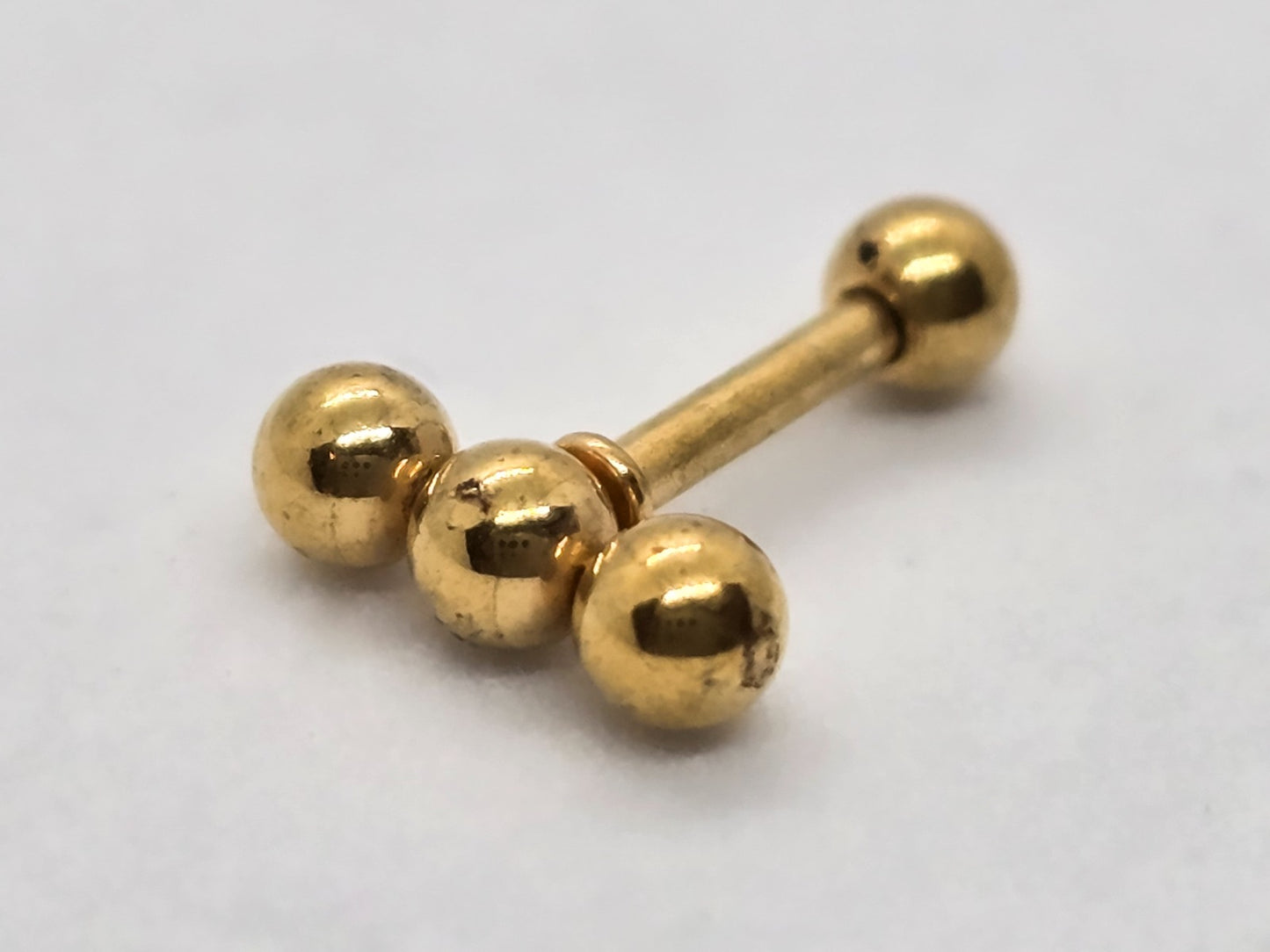 PIERCING TRES ESFERITAS EN LINEA; TONO DORADO