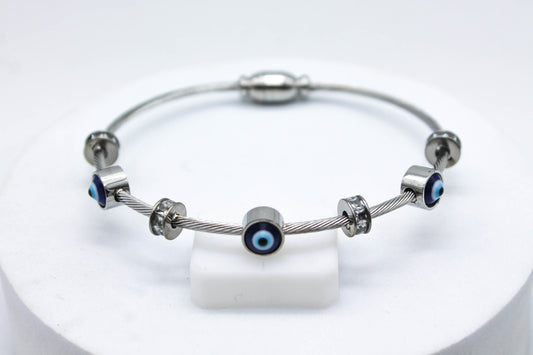 BRAZALETE TRES OJOS TURCOS Y CIRCONIAS; TONO PLATEADO