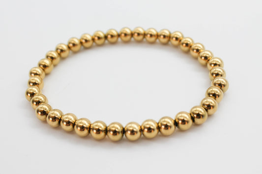 PULSERA ELASTICO ESFERAS 3 MM, TONO DORADO