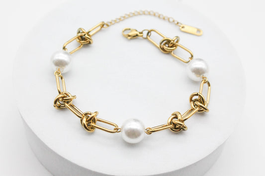 PULSERA ESLABONES ESCALONADOS CON NUDO PERLAS SINTÉTICAS 18CM + EXTENSION DE 5CM , TONO DORADO