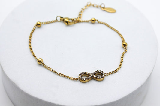 PULSERA INFINITO CIRCONIAS Y ESFERITAS; TONO DORADO