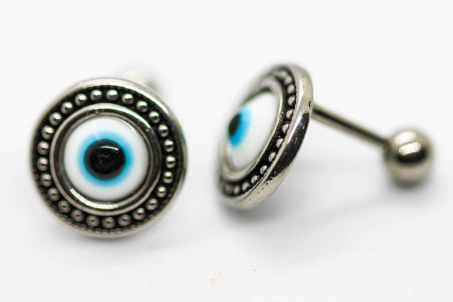 BROQUELES OJO AZUL CON TOPE DE ROSCA; TONO PLATEADO