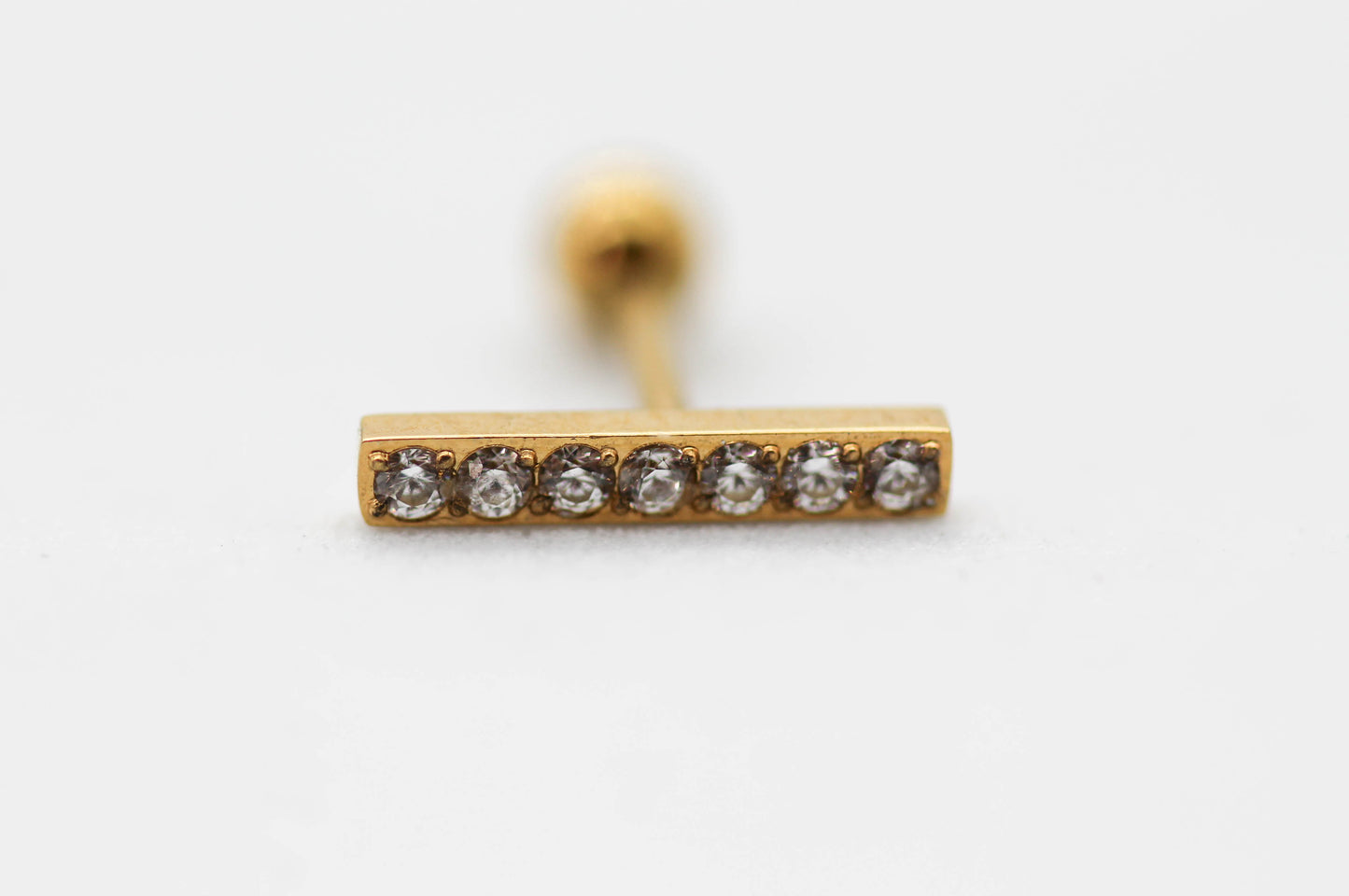 PIERCING BARRA RECTANGULAR 10MM - 7 MINI CIRCONIAS; TONO DORADO