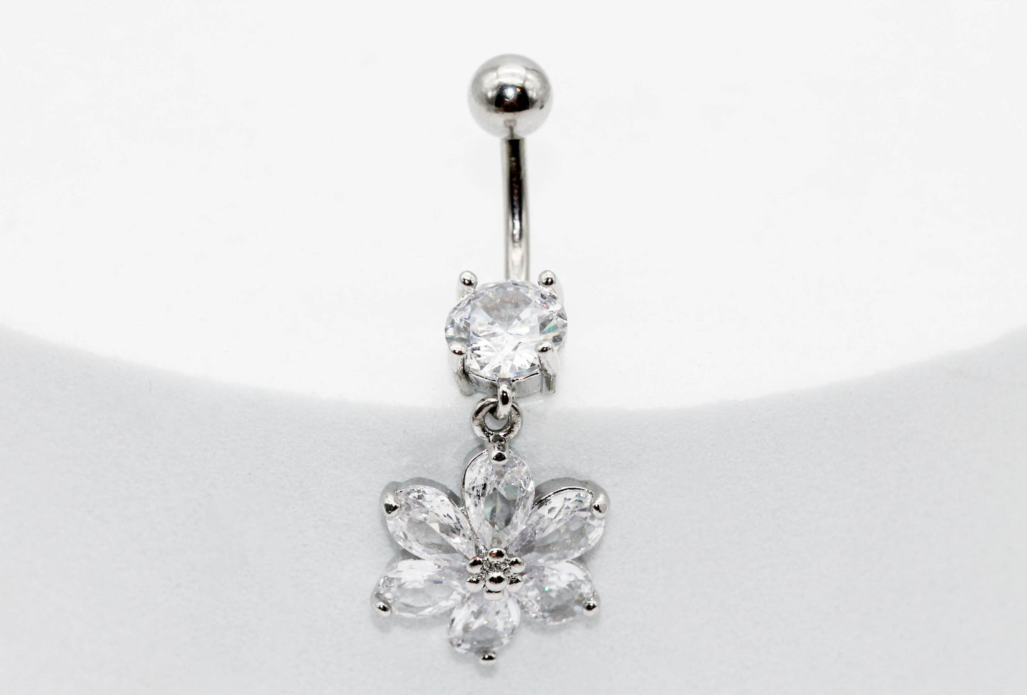 PIERCING OMBLIGO CIRCONIA MONTADA 7MM FLOR 6 PETALOS  17X16MM ; TONO PLATEADO