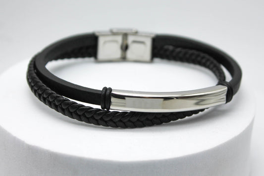 PULSERA CABALLERO PIEL NEGRA DOBLE PLANA Y TRENZADA PLACA ACERO; TONO PLATEADO