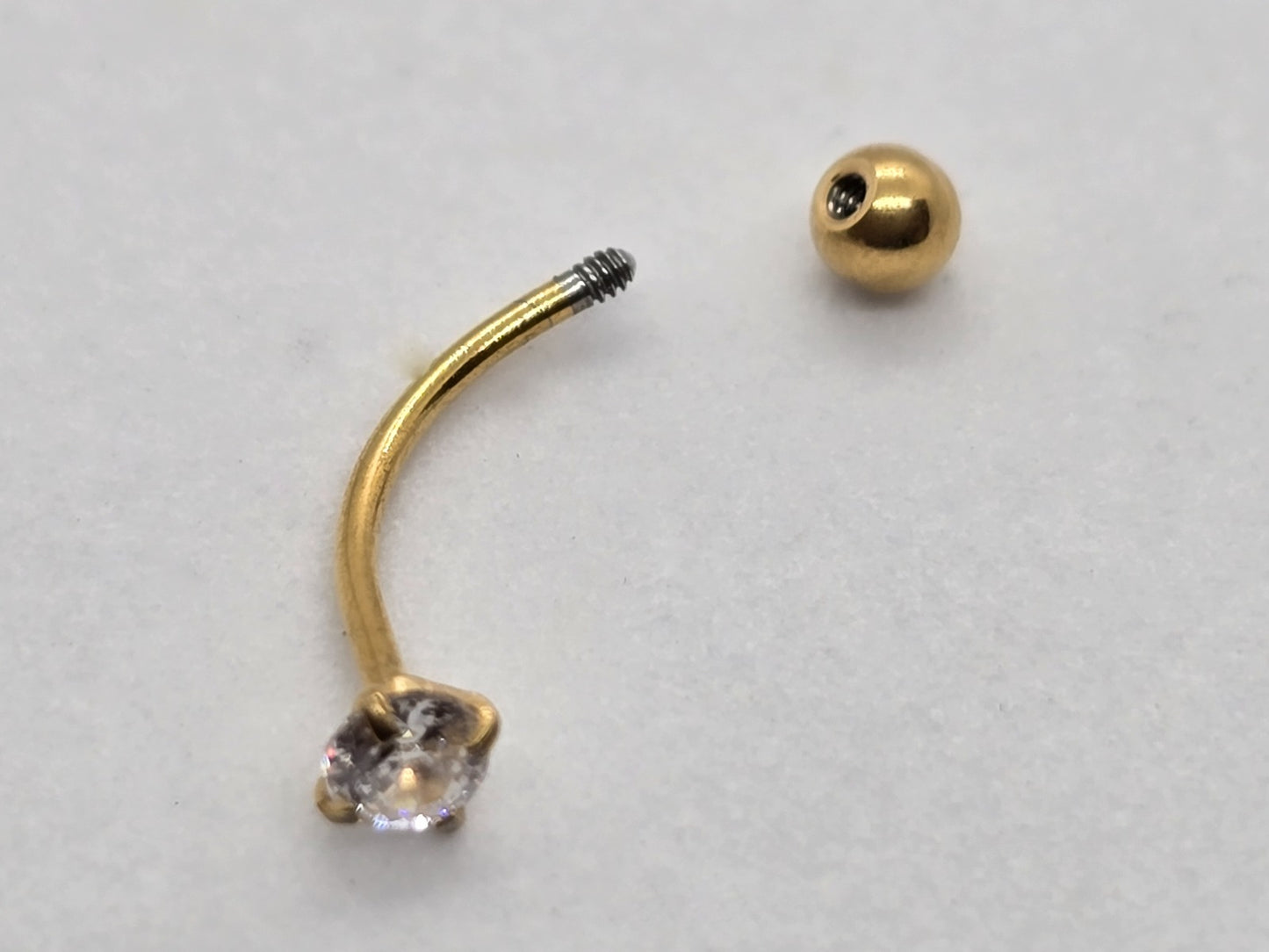 PIERCING ARCO CIRCONIA; TONO DORADO