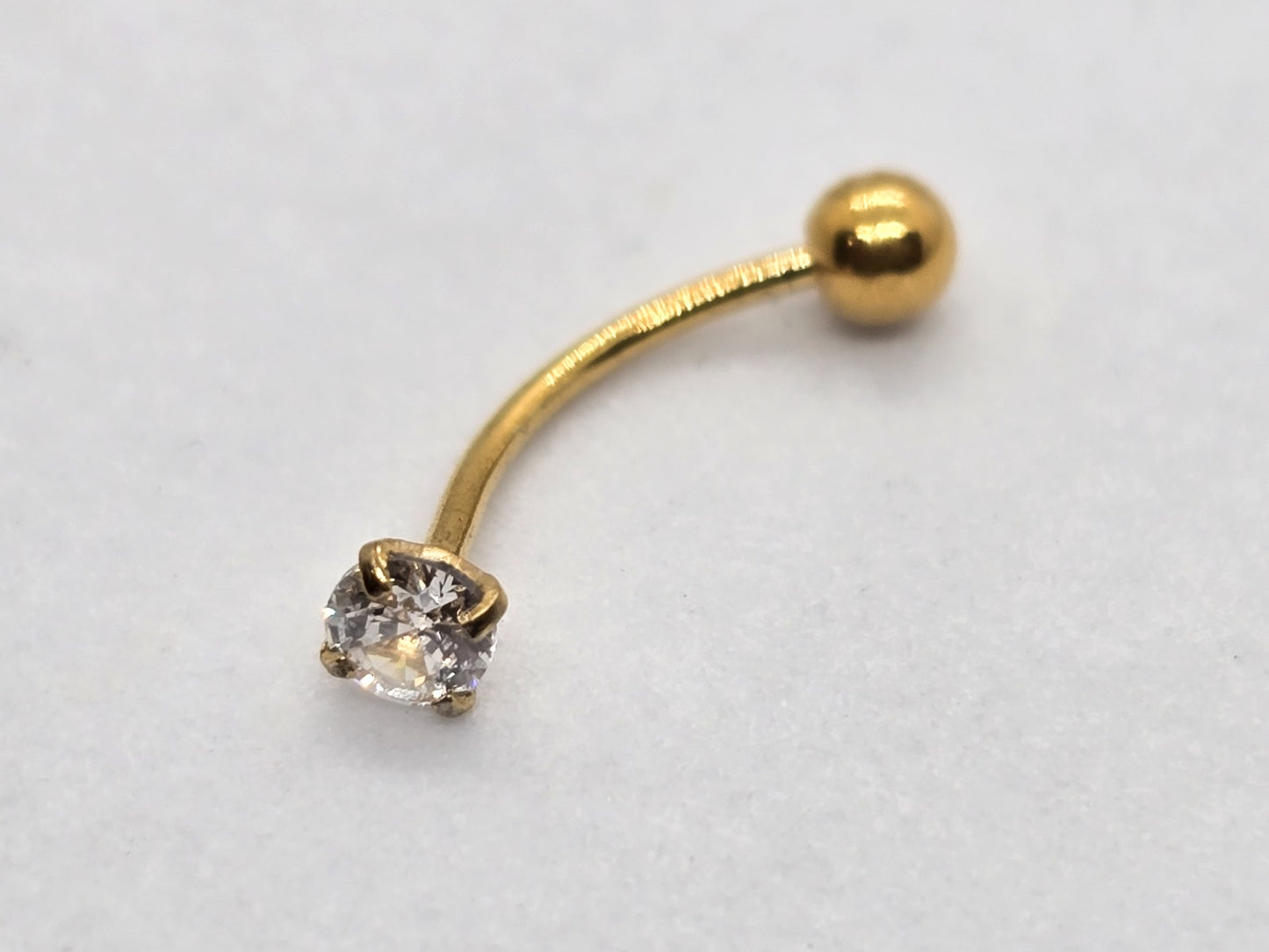 PIERCING ARCO CIRCONIA; TONO DORADO