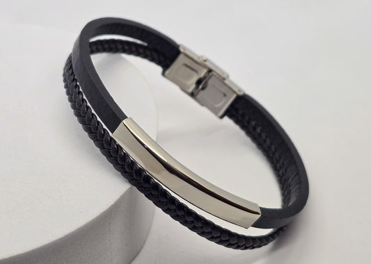 PULSERA CABALLERO PIEL NEGRA DOBLE PLANA Y TRENZADA PLACA ACERO; TONO PLATEADO