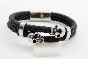PULSERA 2 CALAVERAS EN 2 TRENZAS NEGRAS